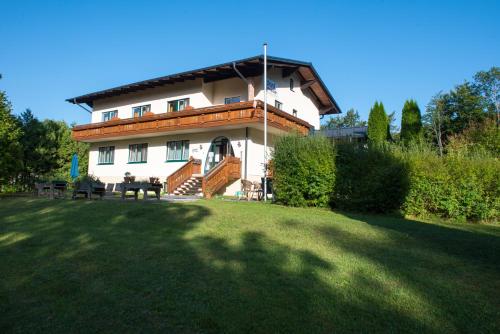 a large house with a lawn in front of it at Dorfpension Mariahilfberg in Gutenstein