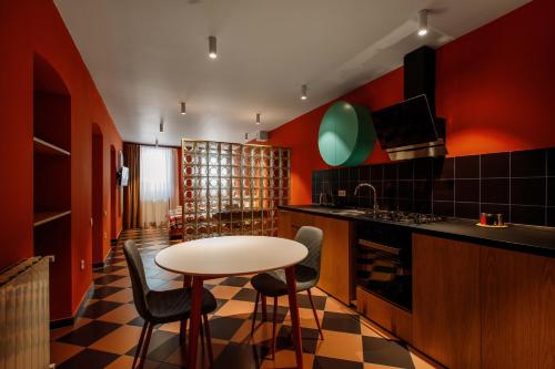 a kitchen with a table and chairs in a room at Urban Apartments 23 in Tbilisi City