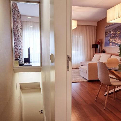 a living room with a couch and a dining room at Casa da Praça in Miranda do Douro