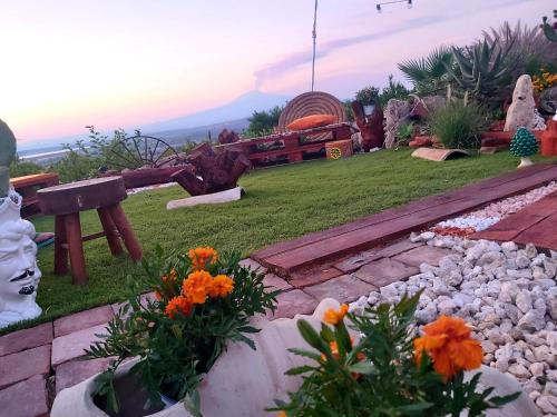a garden with flowers and a train in the background at La Terrazza di Cirico' in Carlentini
