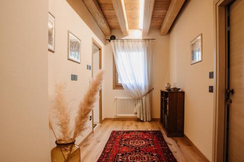 a hallway with a window and a rug at Ca'Lisel in Valdobbiadene