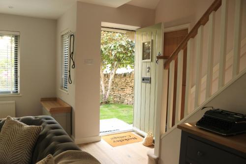 a living room with a door leading to a yard at Beautiful Cottage in the Heart of Stow on the Wold in Stow on the Wold