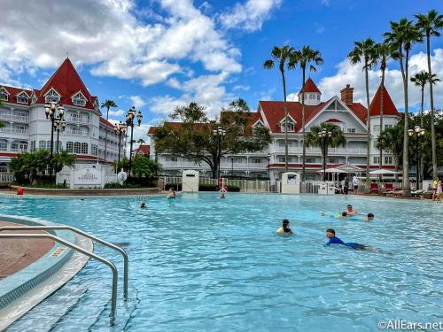 a group of people in a swimming pool at a resort at Disney’s Grand Floridian Resort in Orlando