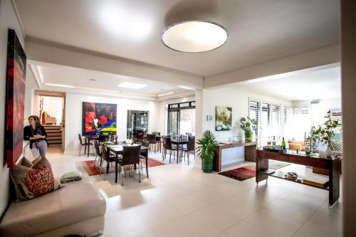 a woman sitting on a couch in a living room at Selkirk House in Hermanus