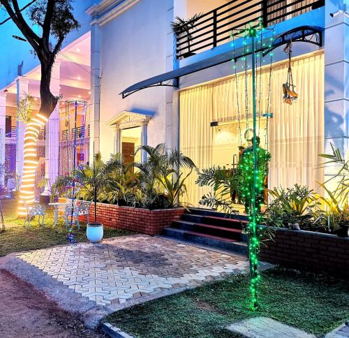 a house with a green christmas tree in front of it at Hotel NorthWay in Vavuniya