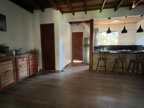 a kitchen with a counter and a table and chairs at Casa.dovale in Caeté-Açu