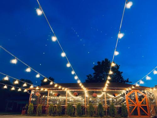 a marquee lit up at night with lights at Čill Easy hotel with self check-in in Ādaži