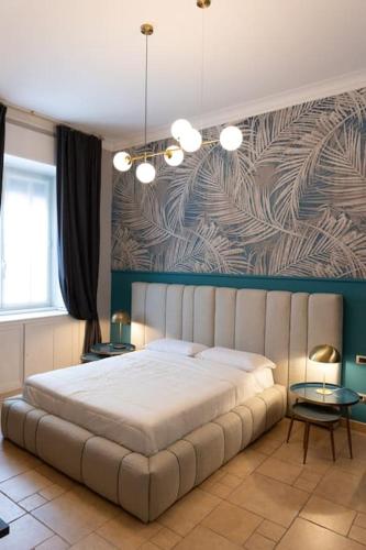 a bedroom with a large bed and a wall with a painting at Spazio SIMA Space 2 - 1 in Milan