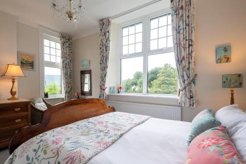 a bedroom with a bed and a window at The Mount B&B in Keswick