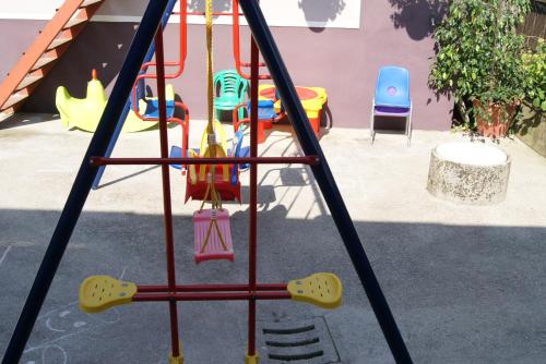 a swing set at a playground in a yard at Rooms & Apartments Kepic, AIRPORT accomodation in Cerklje na Gorenjskem