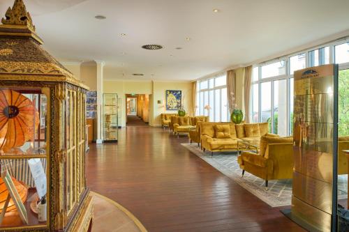 a lobby with couches and chairs in a building at Grand Hotel Binz in Binz