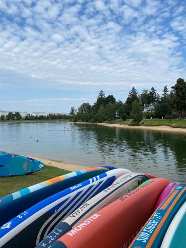 a row of kayaks sitting on the shore of a lake at Apart Hotel Jablonec in Jablonec nad Nisou