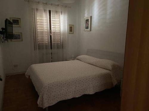 מיטה או מיטות בחדר ב-La Casetta di San Leonardo I.U.N.Q2439