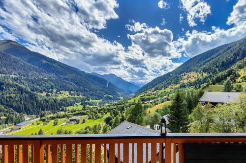 a balcony with a view of a valley with mountains at Chalet Bijou in Blitzingen
