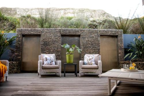 two chairs and a table on a patio at Selkirk House in Hermanus