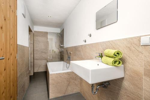 a bathroom with a white sink and a shower at Oberköbenhof Wohnung Tal in Laces