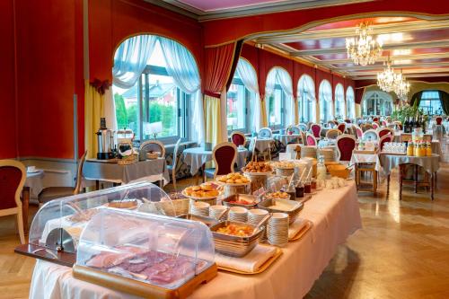 a large banquet hall with tables with food on them at Hôtel Beau Site in Malbuisson