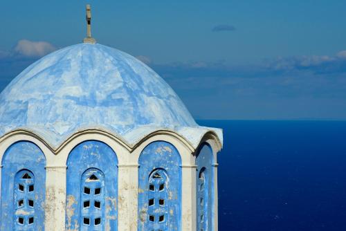 a blue and white building with a cross on top at Endless green 1 Arethousa Ikaria in Arethousa