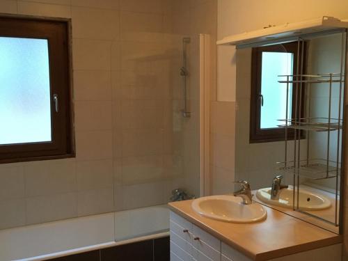 a bathroom with two sinks and a mirror at Appartement Les Gets, 4 pièces, 6 personnes - FR-1-671-99 in Les Gets