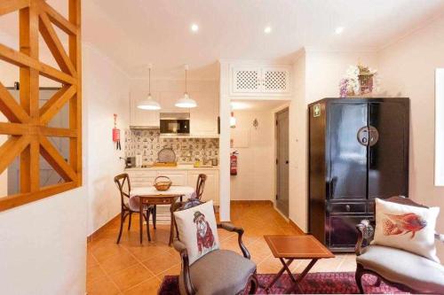 a kitchen and living room with a refrigerator and a table at Villa Estefânia em Sintra in Sintra