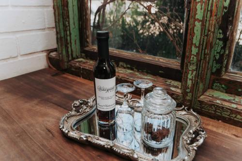 a bottle of wine in a tray on a table at Upington African Vineyard Boutique Hotel & SPA in Kanoneiland