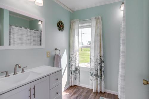 a bathroom with a sink and a window at Cozy Greenwich Vacation Rental with Fire Pit in Greenwich