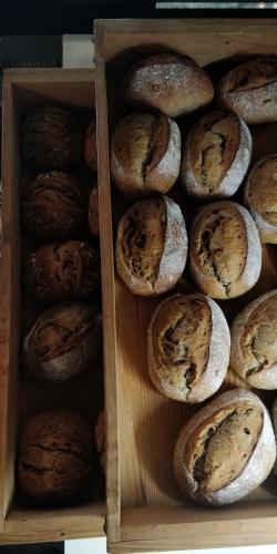 a wooden box filled with lots of different types of bread at YUMEJI Vintage Villa in Kyoto