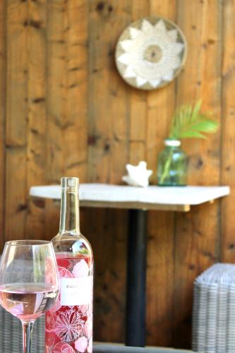 a bottle of wine and a glass on a table at Casa Mantana Bonaire in Kralendijk