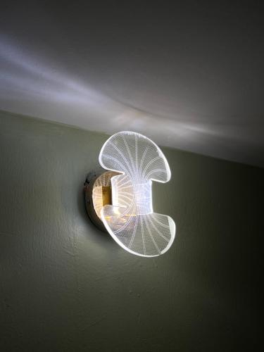 a light with a letter b on a ceiling at Fivas Residences in Arua