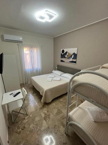 a bedroom with a bed and two bunk beds at B&B Casa Doria in Valmontone