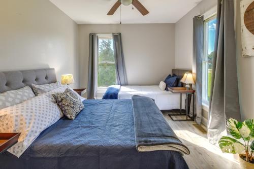 a bedroom with a bed with a blue comforter at Tranquil Cottage in Virginia Countryside with Pond! in Midlothian