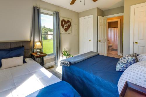 a bedroom with two beds and a large window at Tranquil Cottage in Virginia Countryside with Pond! in Midlothian