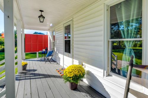 a porch of a white house with a window at Tranquil Cottage in Virginia Countryside with Pond! in Midlothian