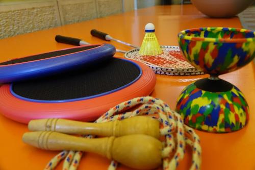 a table with colorful plates and utensils on it at Haus zur Rose, St.Gallen, Bodensee, Säntis in Speicher