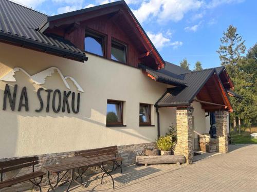 a building with a sign on the side of it at Na Stoku in Istebna