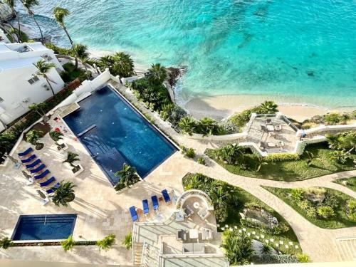 an aerial view of a house and the ocean at Beachfront luxury 2br condo in Lowlands