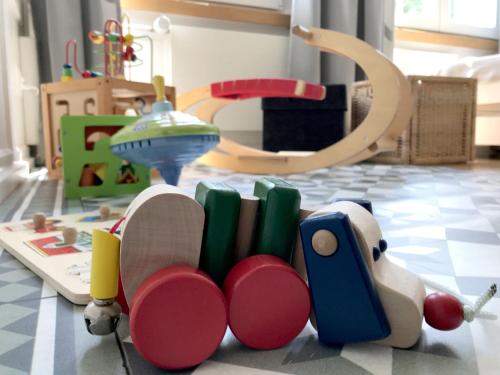 a toy train and books on a floor at Haus zur Rose, St.Gallen, Bodensee, Säntis in Speicher