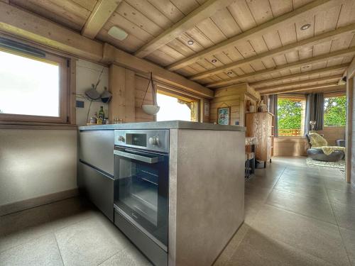 a kitchen with a stainless steel stove top oven at Chalet neuf La Perle du Perron in Cordon