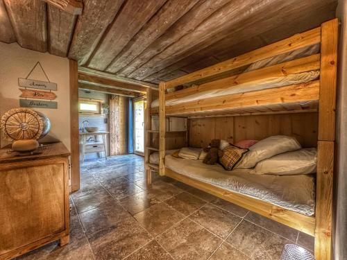 a bedroom with two bunk beds in a cabin at Chalet neuf La Perle du Perron in Cordon