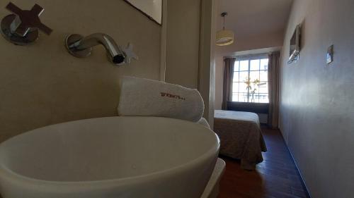 a bathroom with a bath tub in a room at King's Hotel in Buenos Aires