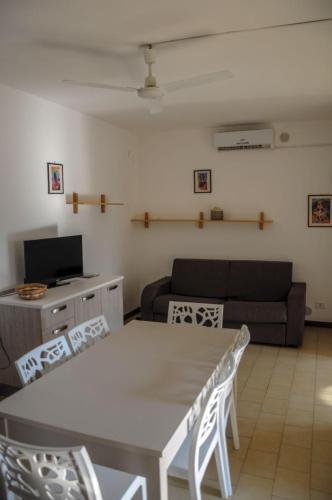 a living room with a table and a couch at Residence Sunbeam in Leporano Marina