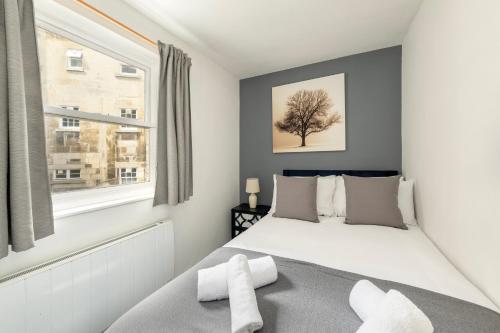 a bedroom with a bed and a tree on the wall at Super City Centre Apartment - two bedrooms, perfect location in Bath