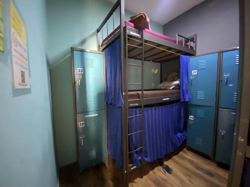 a room with a bunk bed and blue lockers at Aurora Hostel Rio in Rio de Janeiro