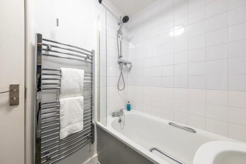 a white bathroom with a tub and a sink at Super City Centre Apartment - two bedrooms, perfect location in Bath