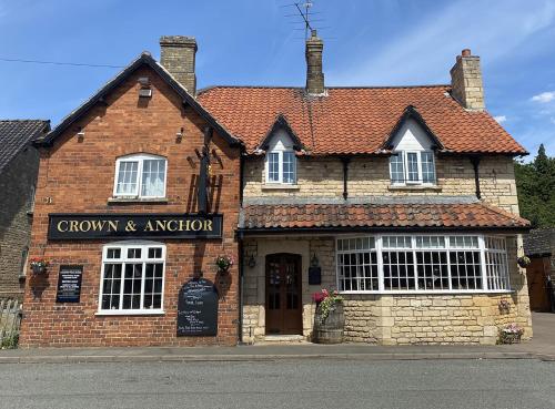 a brick building with a sign on the front of it at Crown & Anchor in Grantham