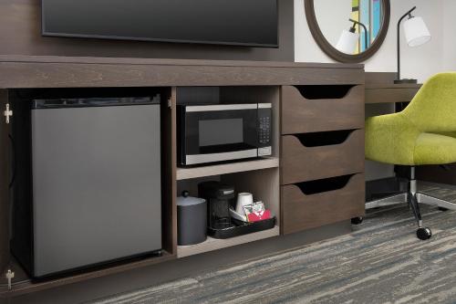a desk with a microwave and a chair at Hampton Inn & Suites Lexington in Lexington