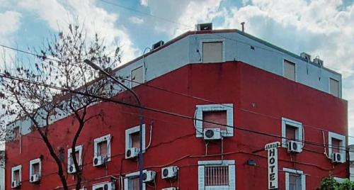 a red building with white windows on top of it at Hotel Jardin de Buenos Aires in Buenos Aires