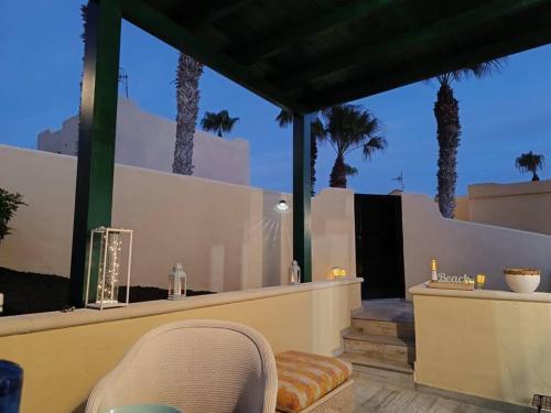 a view of a patio with palm trees in the background at El Caseton in Costa Calma