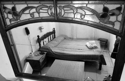 a view of a bedroom with a bed and a mirror at Hotel Jardin de Buenos Aires in Buenos Aires