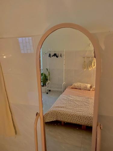 a bedroom with a bed and a mirror at Homestay Tuyết Trinh in Nha Trang